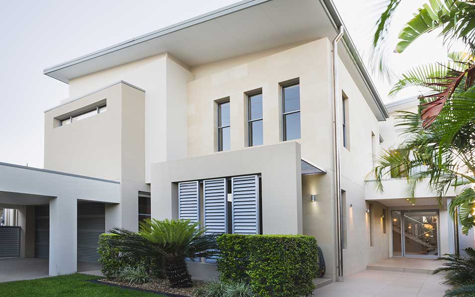 a large white building surrounded by palm trees