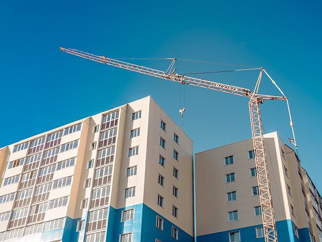 a crane next to a tall building