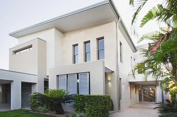 a large white building surrounded by palm trees