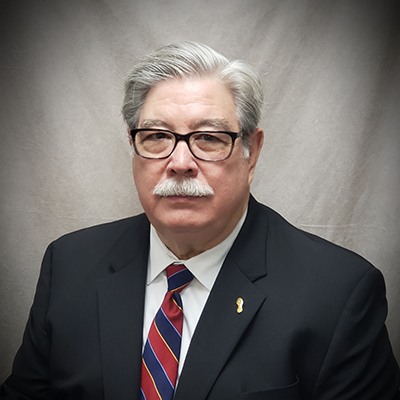 Marcel Granier wearing a suit and tie